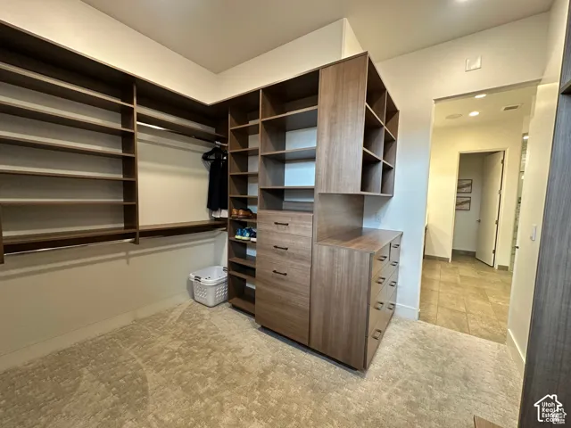 Built-in closet system with shelving, hanging rods, and integrated drawers