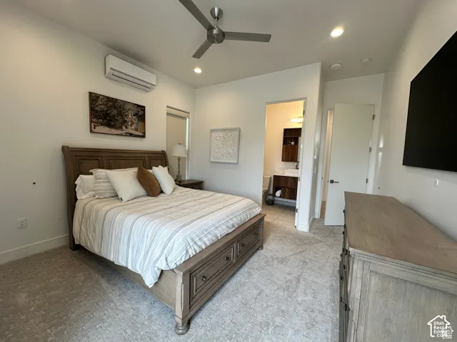 Recessed lighting, ceiling fan, wall-mounted climate control unit, and soft gray carpeting