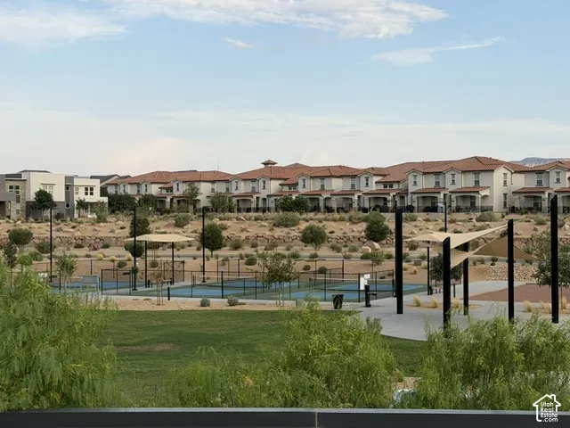 Community green space with a pickleball court and shaded seating areas