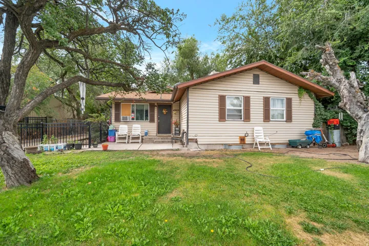 Charming single-story residence with a spacious front lawn anchored by mature shade trees