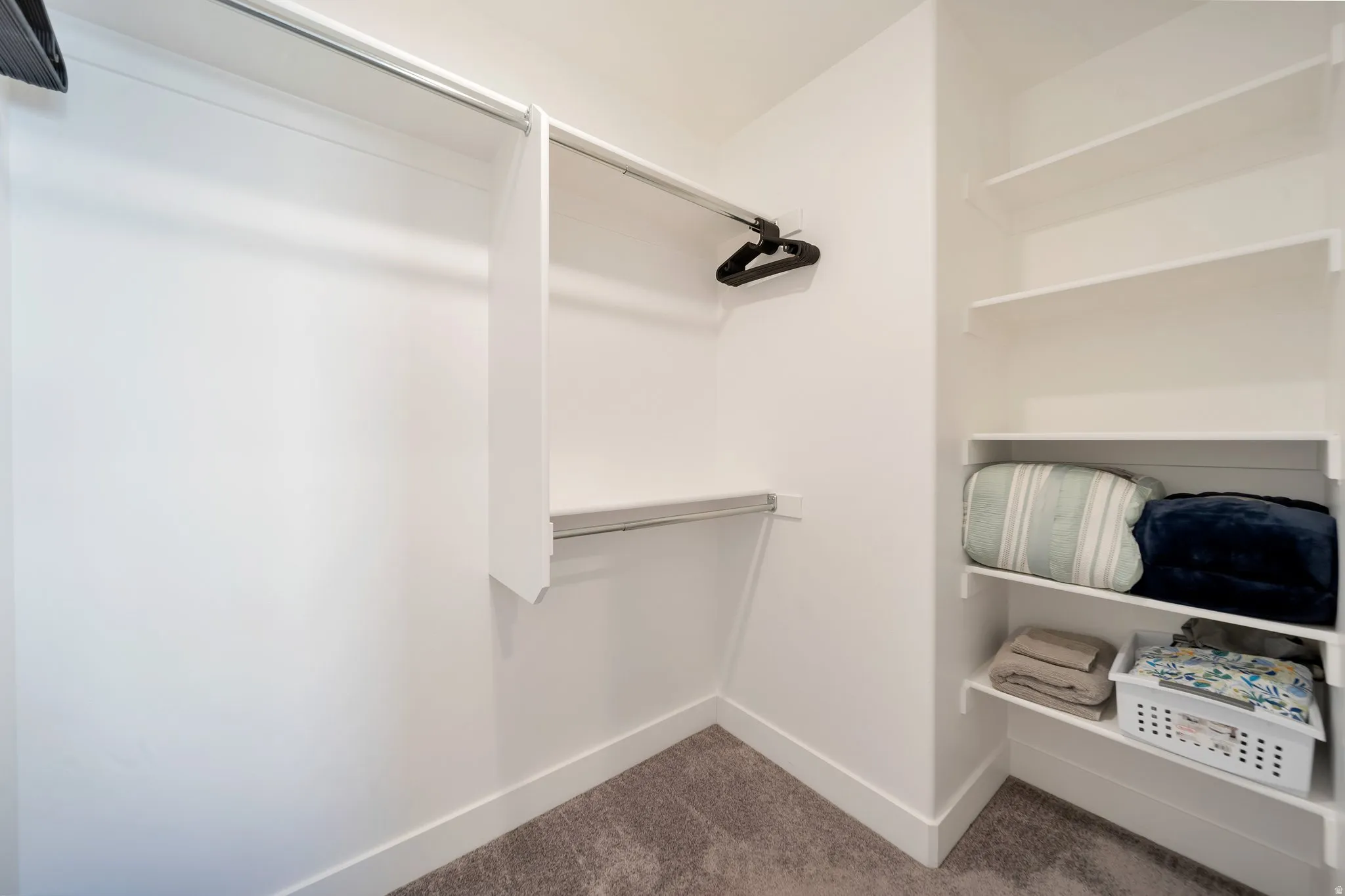 Integrated closet system featuring multiple hanging rods and built-in shelving