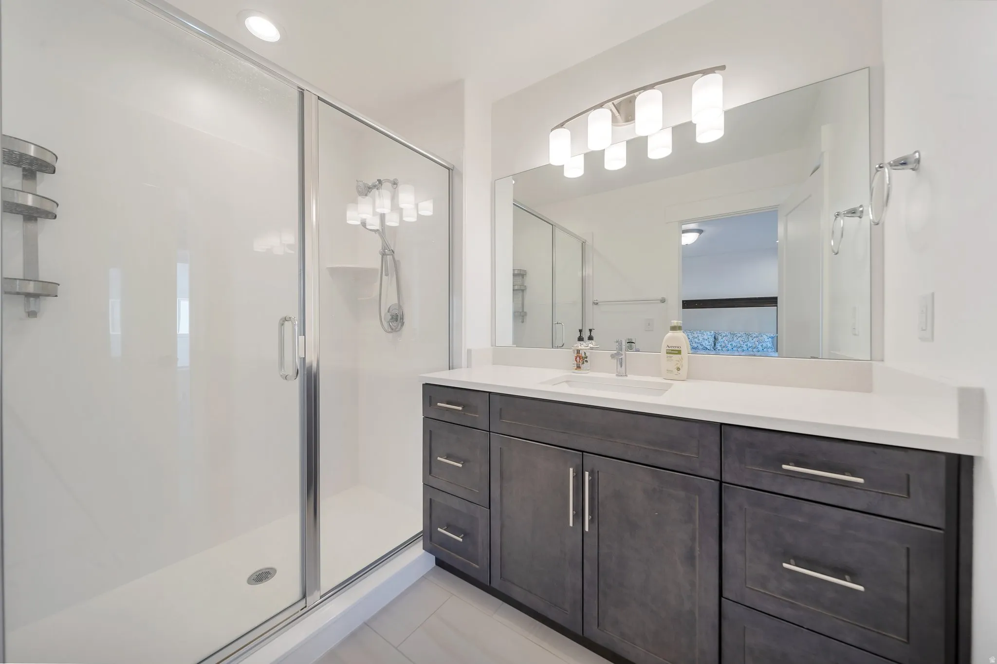 Spacious vanity with a white countertop, undermount sink, and dark wood-finish cabinetry