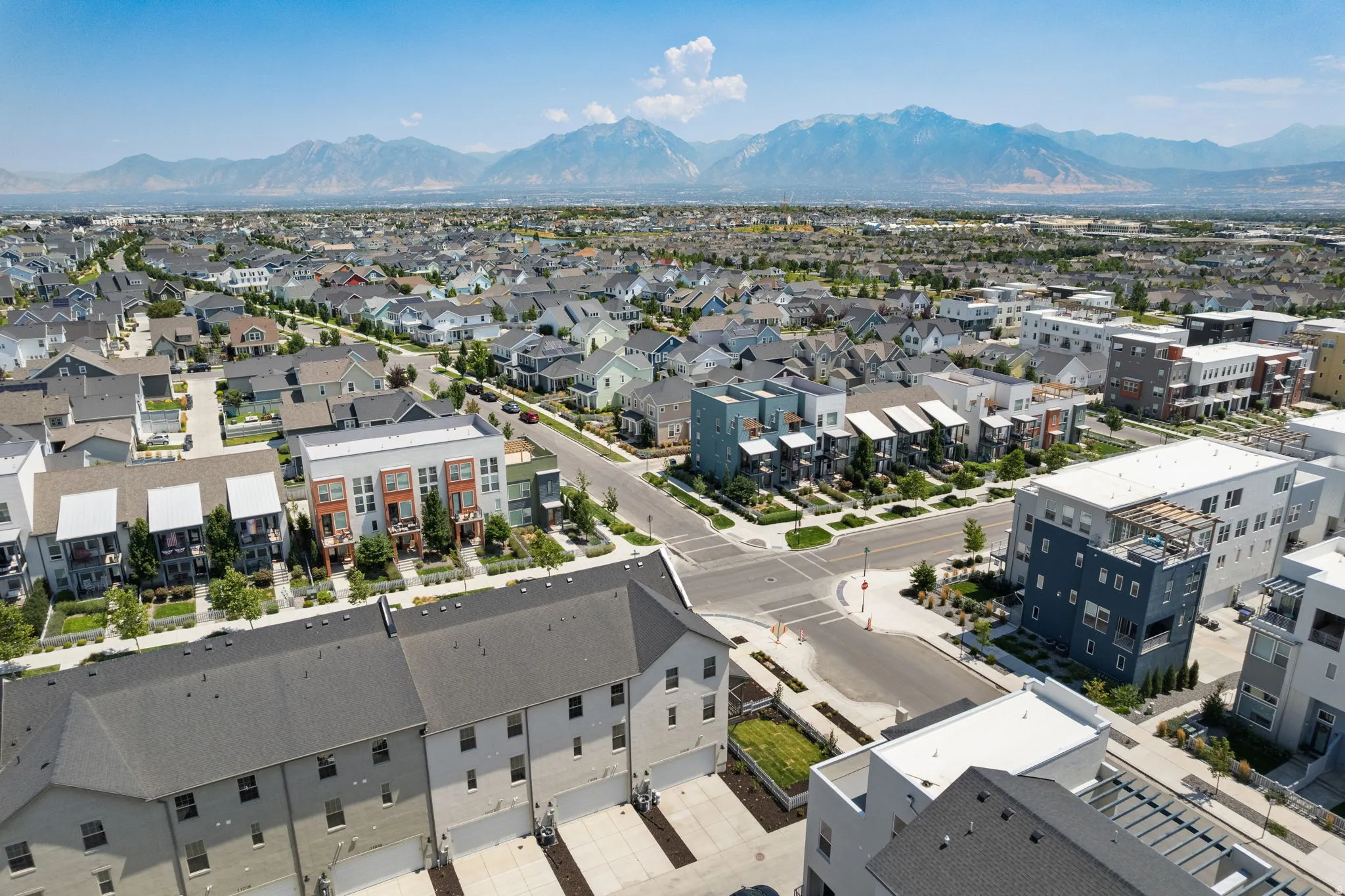 Expansive residential development with a variety of architectural styles, including multi-story townhomes and single-family residences