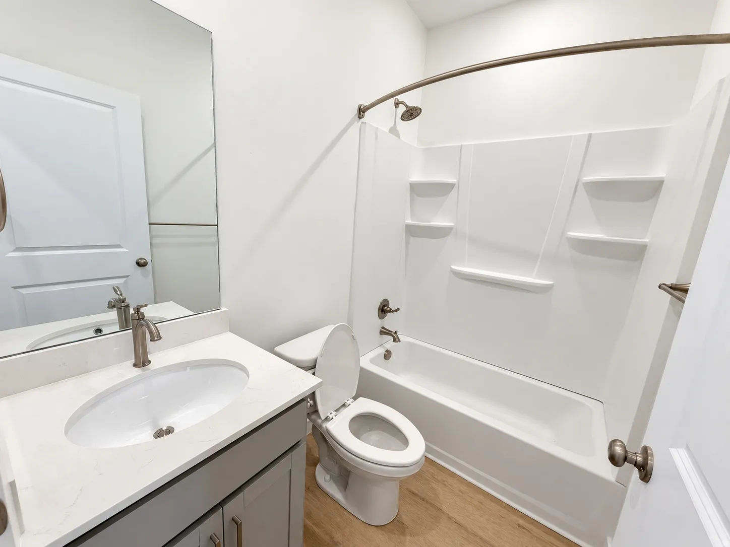 Bathroom featuring a vanity with an undermount sink, a countertop, and wood-finish flooring