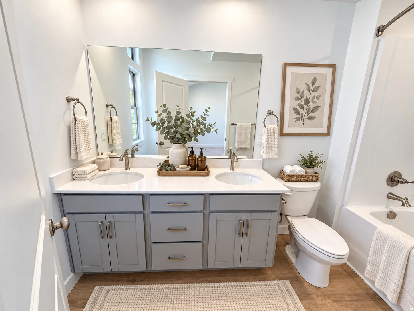 Dual vanity with undermount sinks, stone-finish countertop, and brushed nickel fixtures