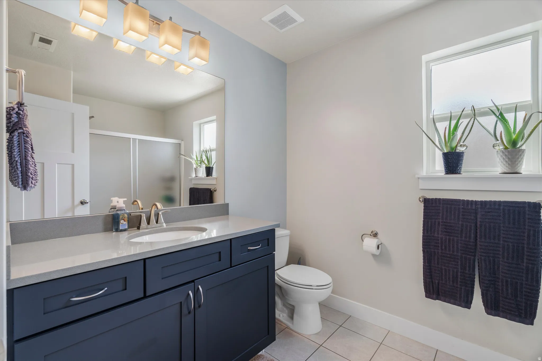 Full upstairs bath services both guest bedrooms & the loft.  All bathroom counters are quartz - a builder upgrade!