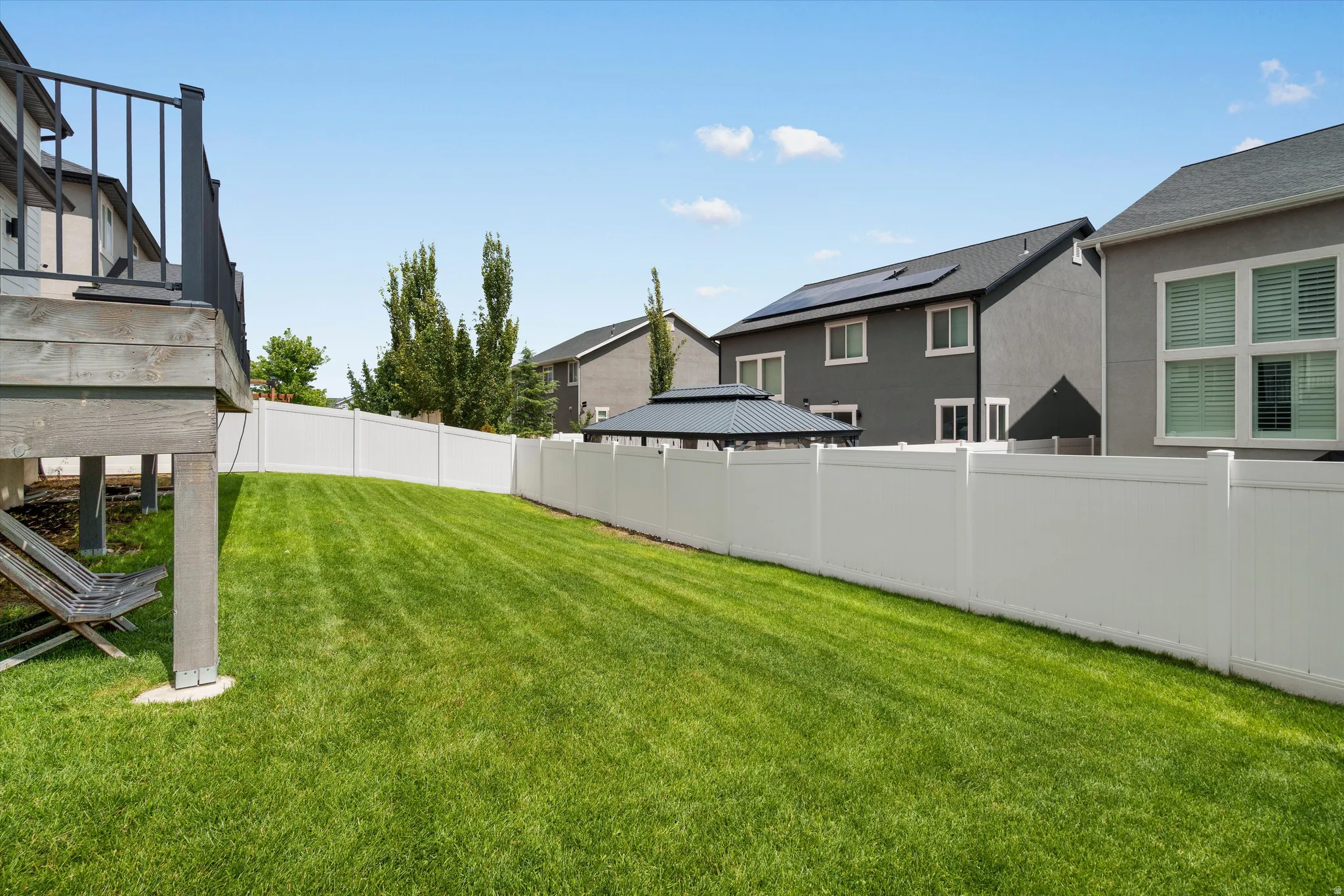 Fully fenced backyard below the deck area runs to both sides of the property - north & south.