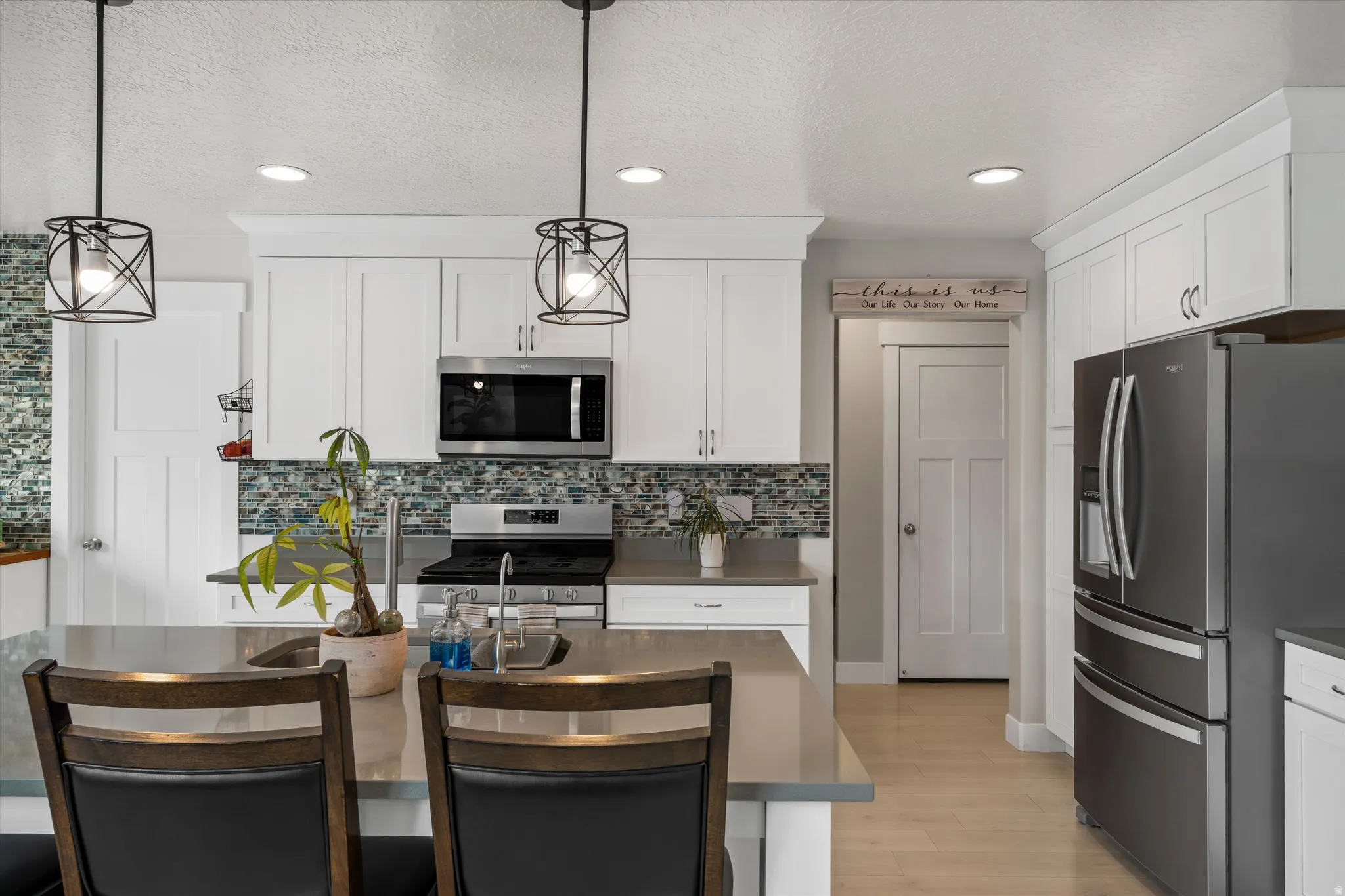 At the right hall is a mud room with bench and storage space.  To the left is the powder room - 1/2 bath.
