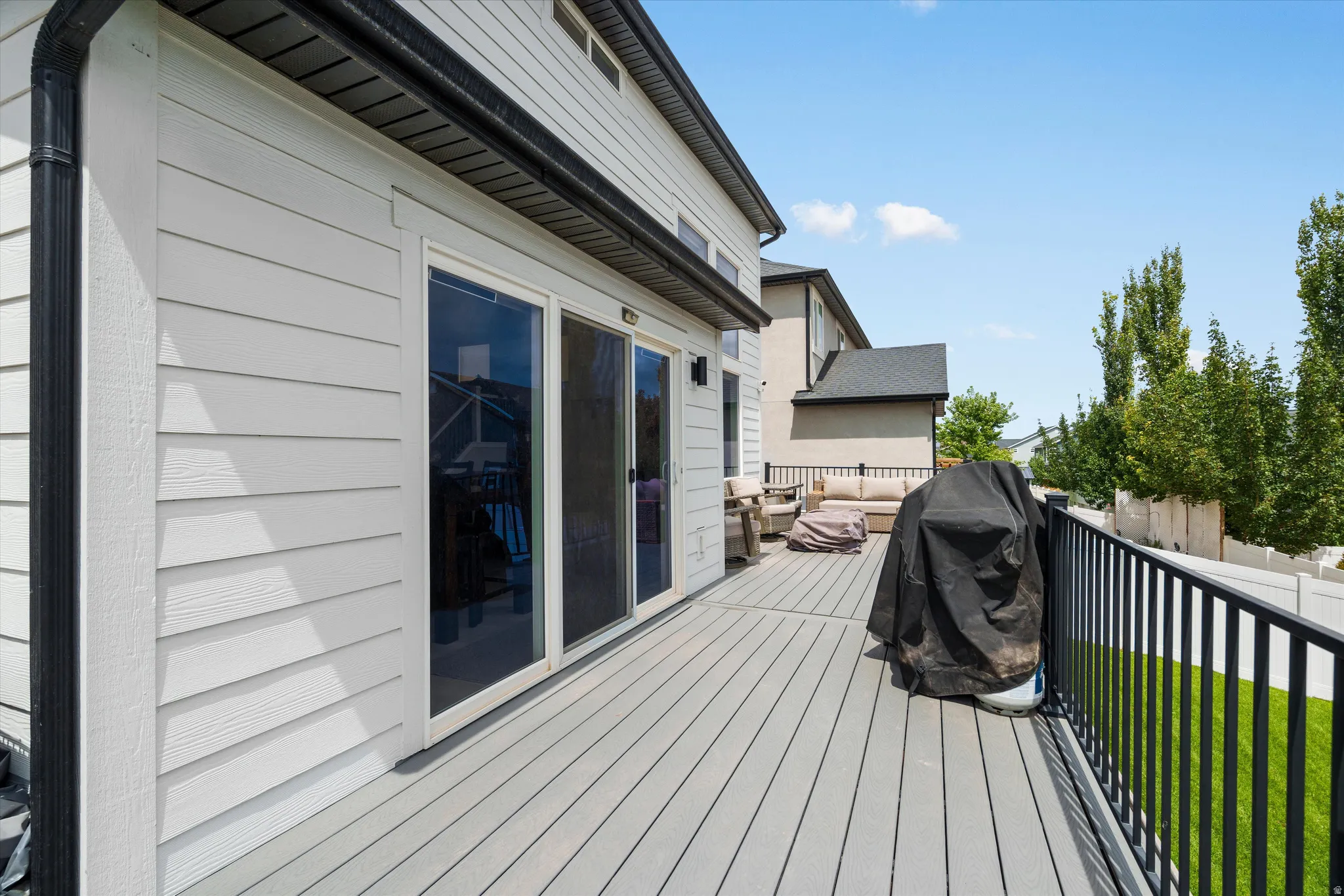 A large trex deck off of the kitchen runs parallel to the kitchen and the living room.