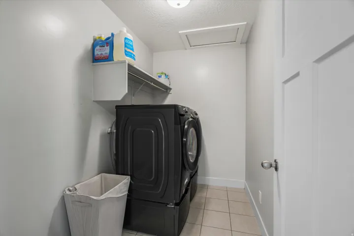 The laundry room is upstairs near both guest bedrooms, primary bedroom and the loft.