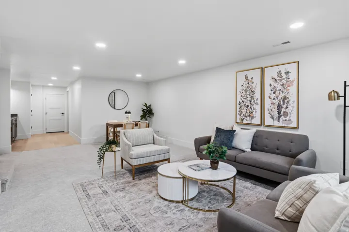 Recessed ceiling lighting, wood-finish flooring, and light-colored carpeting