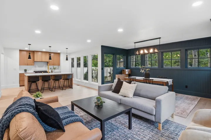 Open-concept living space featuring wood-finish flooring, recessed lighting, and a kitchen with an island