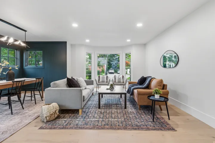 Recessed lighting illuminates the light wood-finish flooring