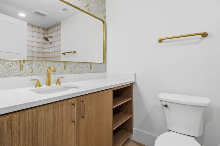 Wood-finish vanity with a white countertop and undermount sink