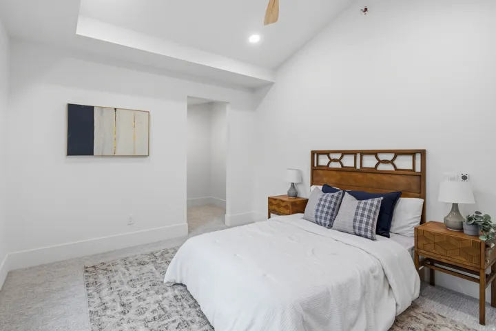 Vaulted ceiling with a ceiling fan, recessed lighting, and carpet flooring