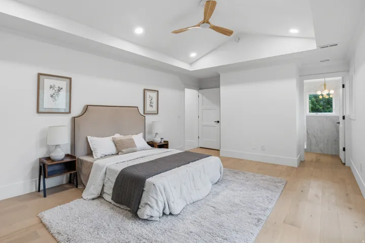 Vaulted ceiling with a wood-finish ceiling fan, recessed lighting, and wood-finish flooring