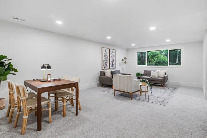 Expansive room with recessed lighting and a large window