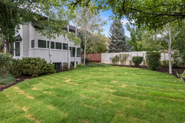 Expansive lawn area with mature trees and established landscaping