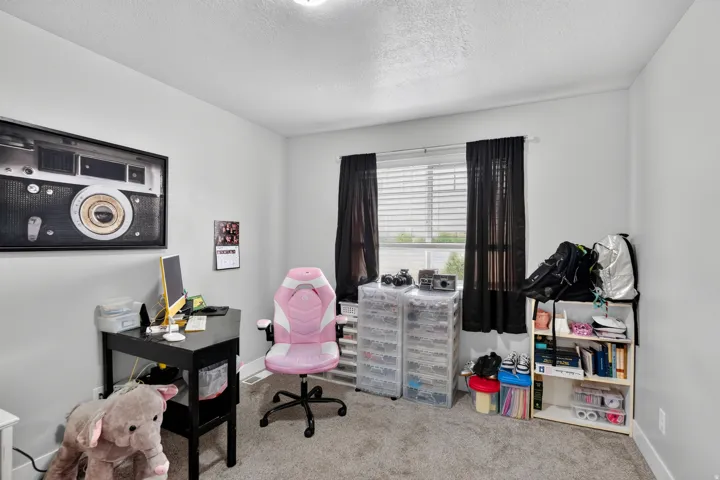 Neutral-toned walls complement the carpeted flooring