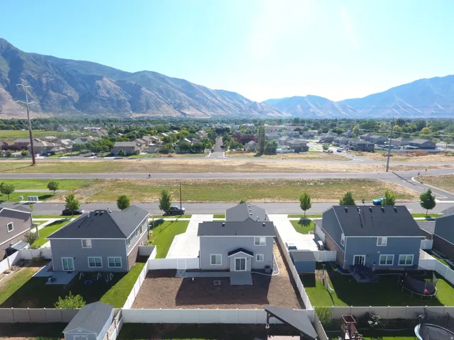 Mountain backdrop, established neighborhood, two-story residence, fenced backyard, concrete driveway