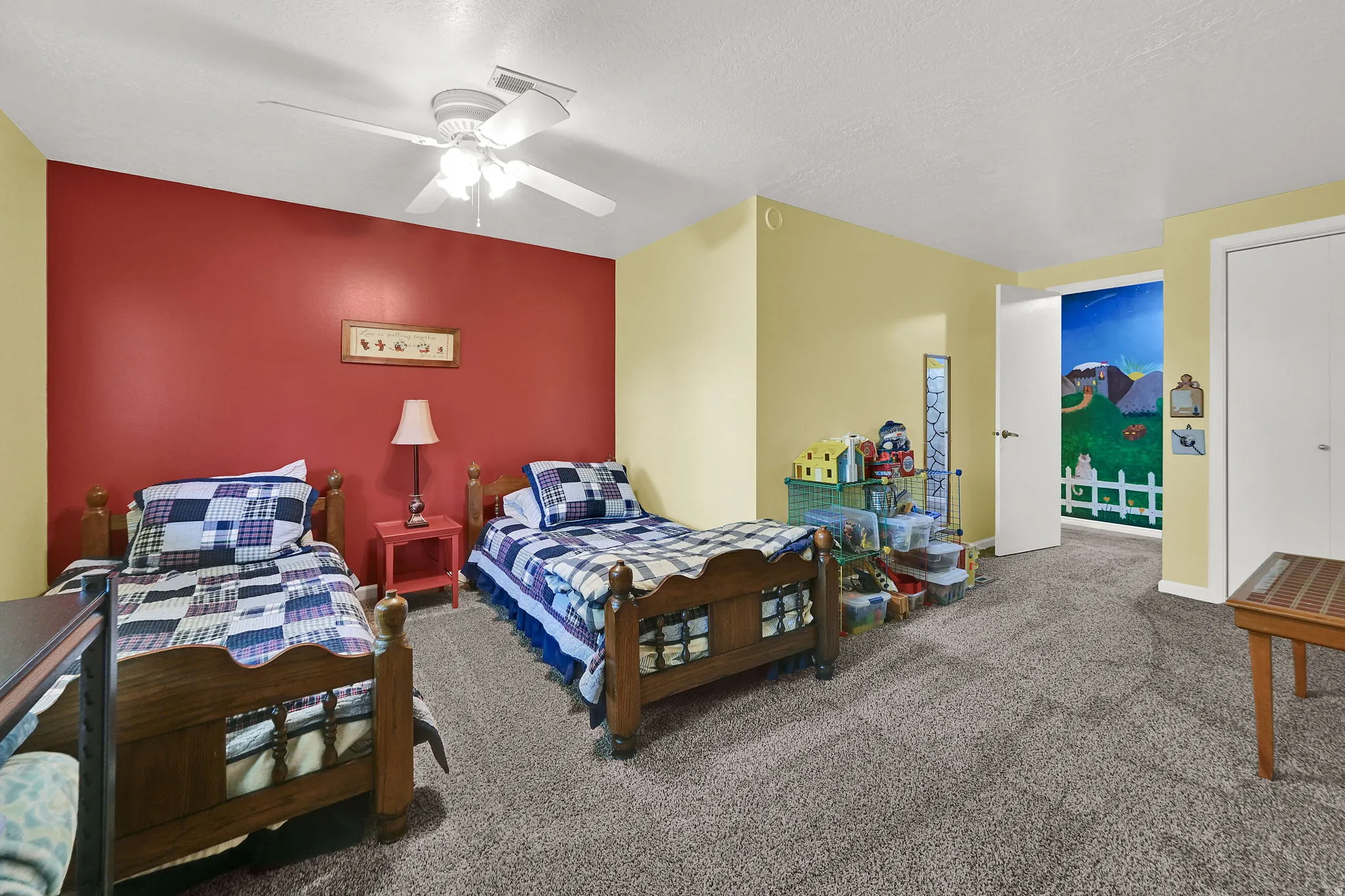 Large bedroom with wall-to-wall carpeting and a ceiling fan with integrated lighting