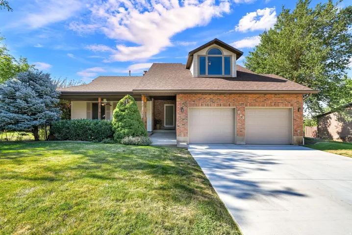 Brick exterior with two-car garage. Home faces North.