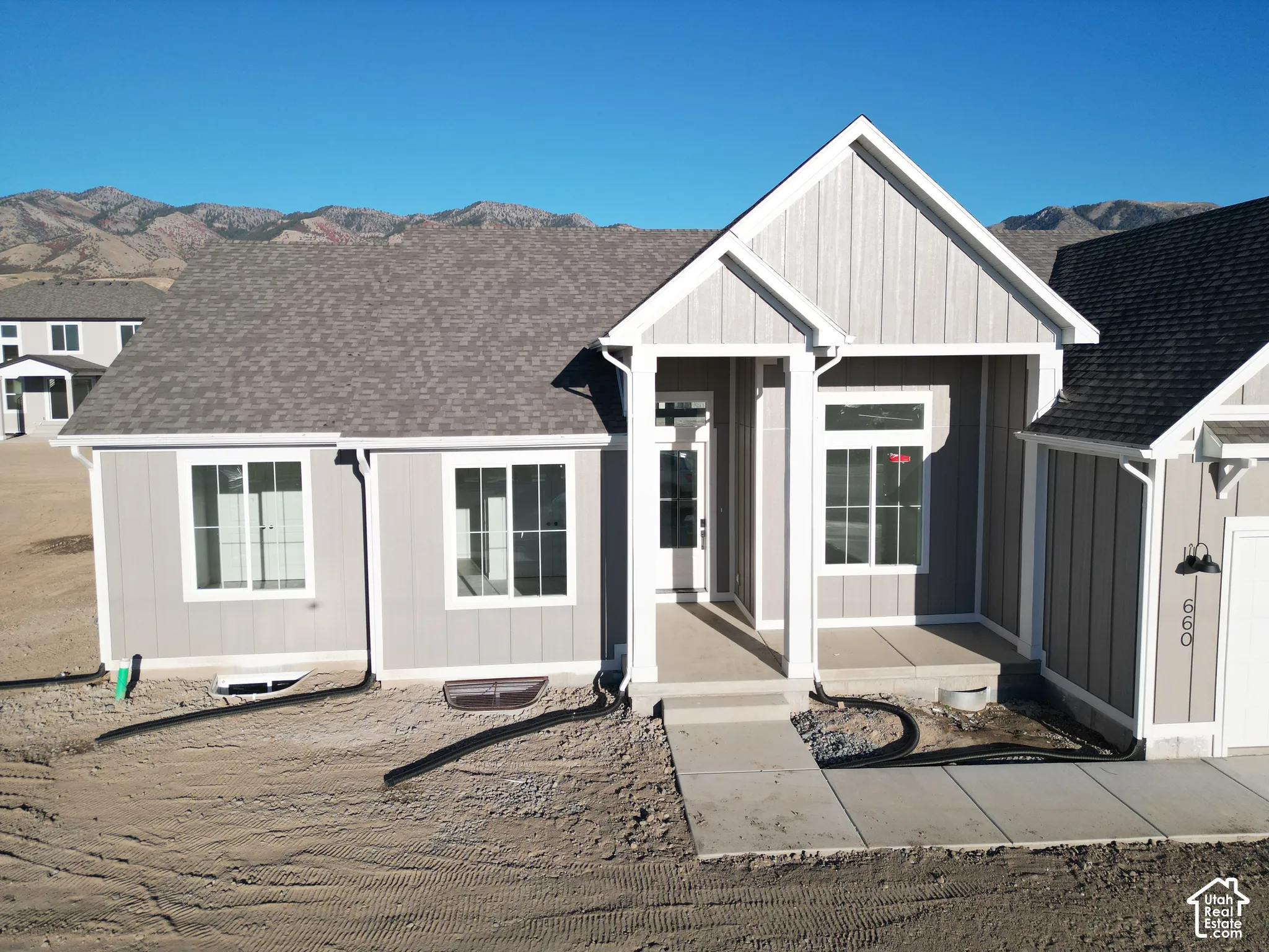 Light gray siding with white trim and a covered front entry