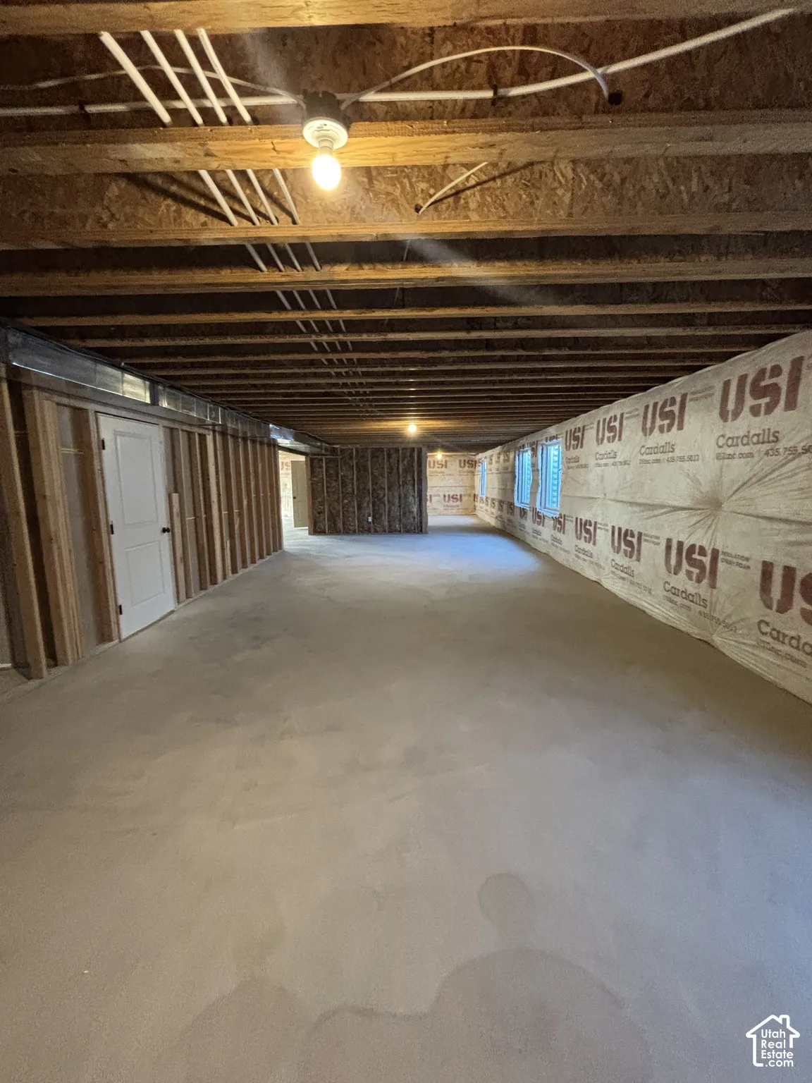 Unfinished lower level featuring exposed ceiling joists, framed interior walls, and concrete flooring