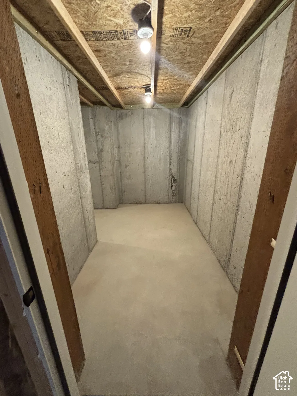 Concrete flooring, exposed ceiling joists, and concrete walls