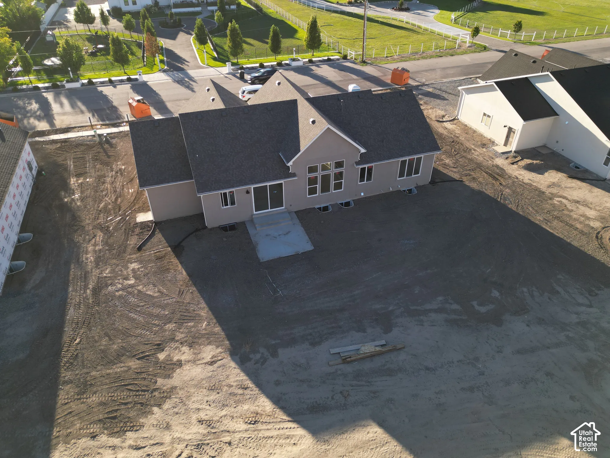 Single-story residence featuring a gray shingle roof, stucco exterior, and multi-pane windows