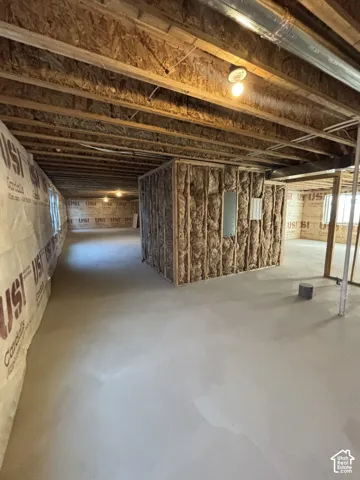 Exposed wood beam ceiling, concrete flooring, framed interior wall, and wall insulation