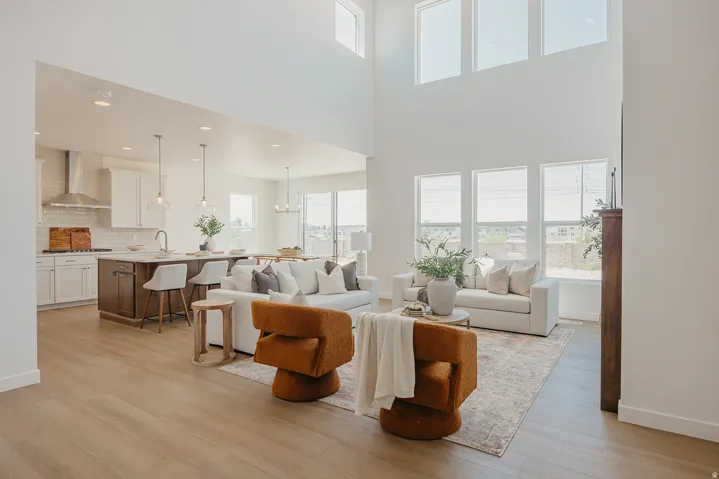 Vaulted ceilings, expansive windows, wood-finish flooring, island kitchen, and stainless steel appliances