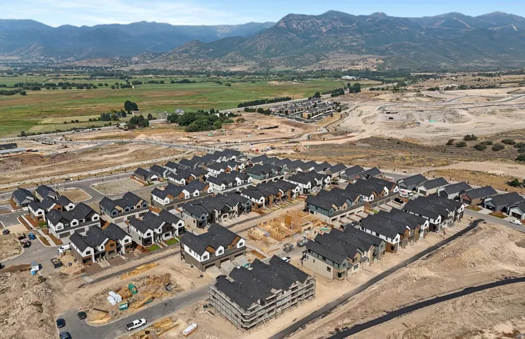 Mountain backdrop with a residential development featuring newly constructed homes and homes under construction