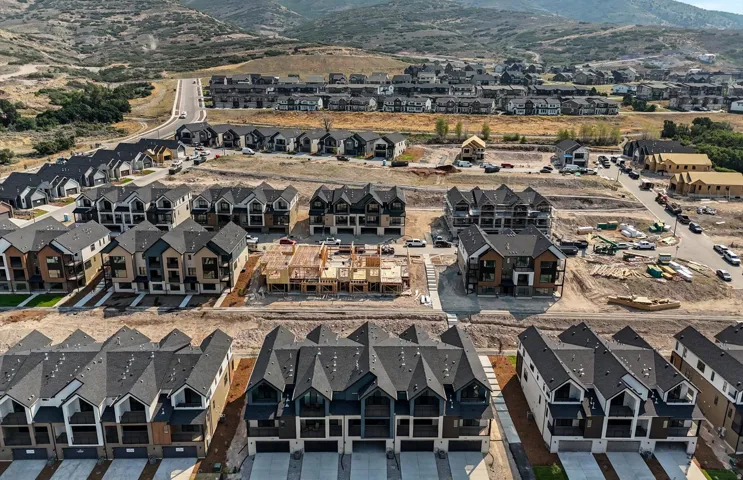 Townhome community with varied architectural styles, multi-story residences, and attached garages
