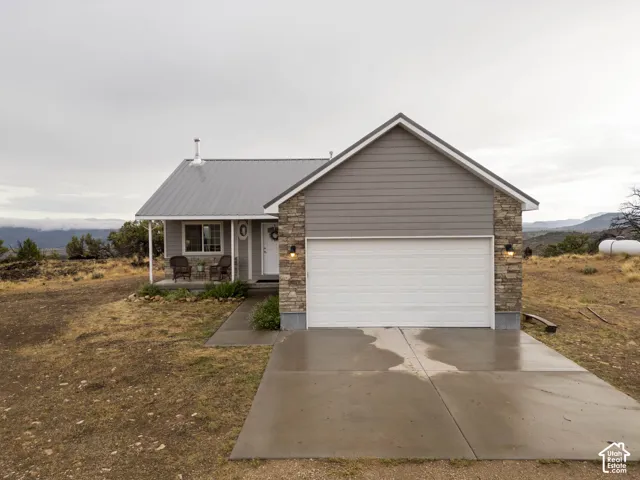 Front view.  Cement walk and 2 car garage.