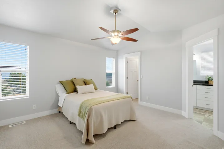 Primary Suite: Spacious bedroom with a large walk-in closet and an oversized bathroom featuring a double-sink vanity and outside entrance.
