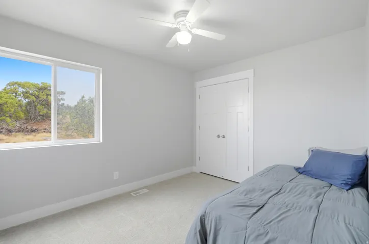 Upstairs bedroom #2 with large window to let natural light in.
