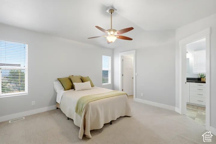 Primary Suite: Spacious bedroom with a large walk-in closet and an oversized bathroom featuring a double-sink vanity and outside entrance.