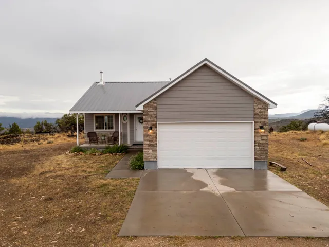 Front view.  Cement walk and 2 car garage.