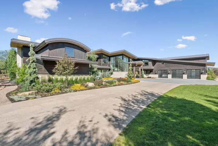 Contemporary architecture with dark wood siding and a curved roofline