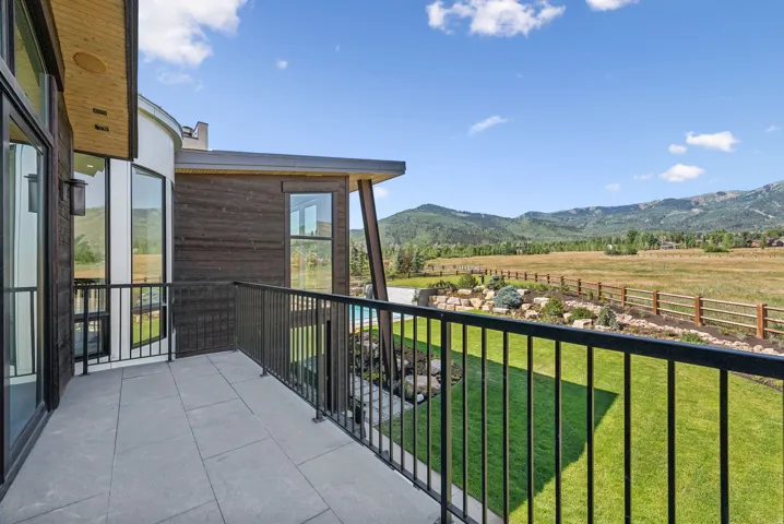 Outdoor balcony with tile flooring and black metal railing
