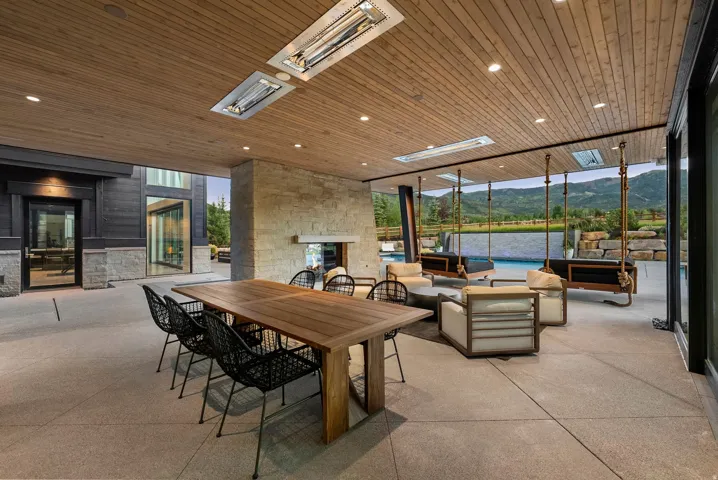 Covered outdoor patio featuring a wood-finish ceiling with recessed lighting and built-in radiant heaters