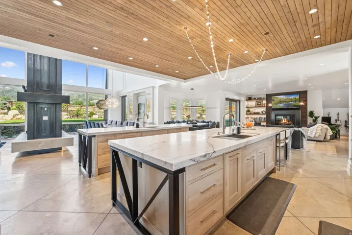 Expansive kitchen featuring two large islands with light-toned cabinetry and substantial countertops