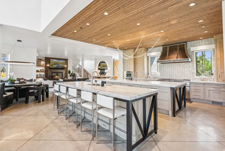Gourmet kitchen with double islands featuring light-toned cabinetry and substantial countertops