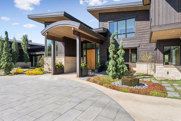 Modern architectural exterior featuring rich wood siding and stone accents