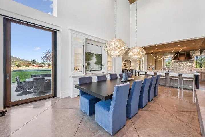 Spacious dining area with concrete flooring and a high vaulted ceiling