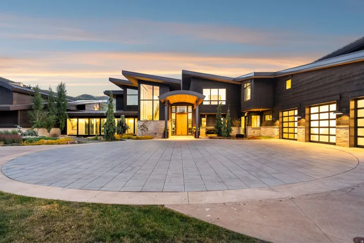 Contemporary architectural style featuring dark wood-finish siding and stone accents
