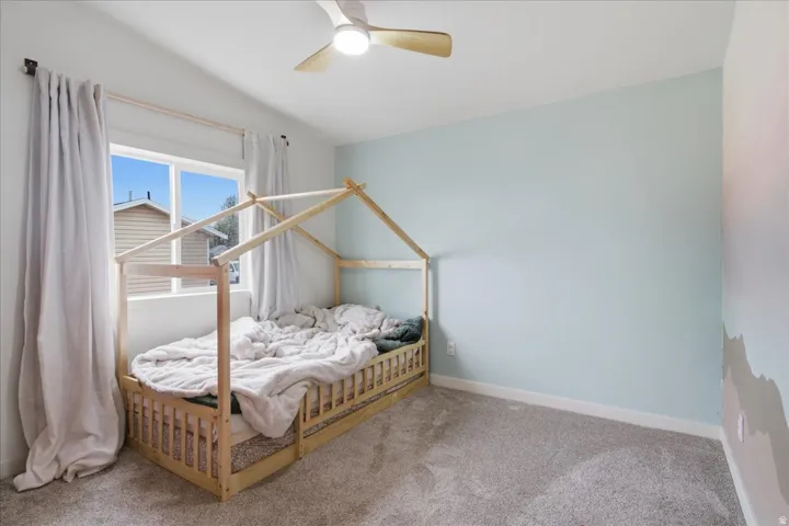 Recessed window with white trim, light-toned walls, and a ceiling fan with integrated lighting