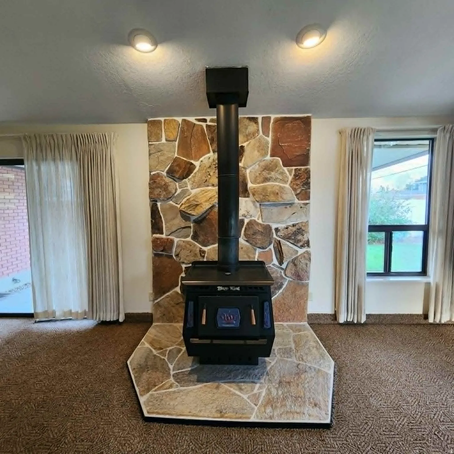 Wood-burning stove with a stone surround and hearth