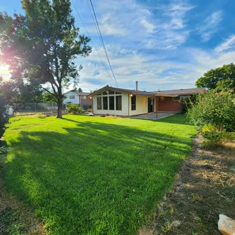Expansive grassy yard with mature trees